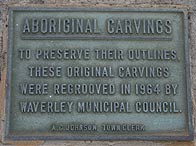Plaque reading 'Aboriginal Carvings: To preserve their outlines these original carvings were regrooved in 1964 by Waverley Municipal Council.