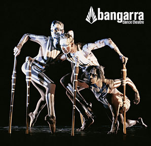 Bangarra Dance Theatre members painted up and holding on to sticks for balance.