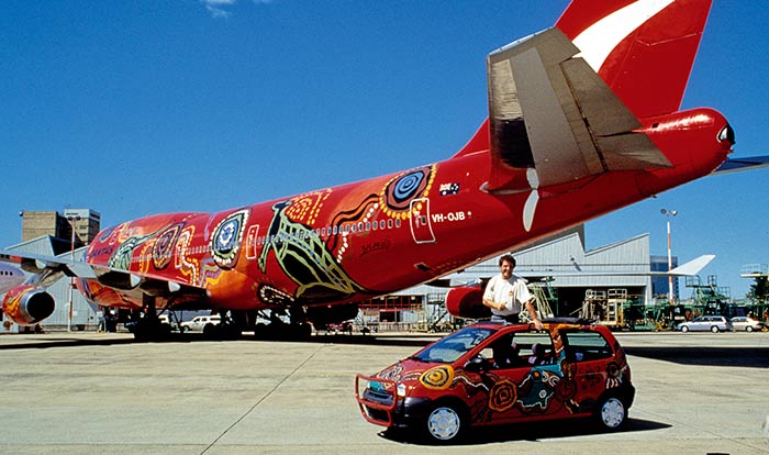 The Twingo stands in front of a massive Boeing air jet on the tarmac at Sydney airport.