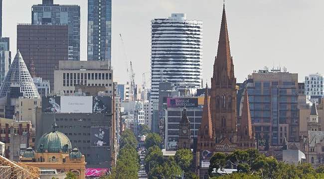 A building with a face looks across the city.