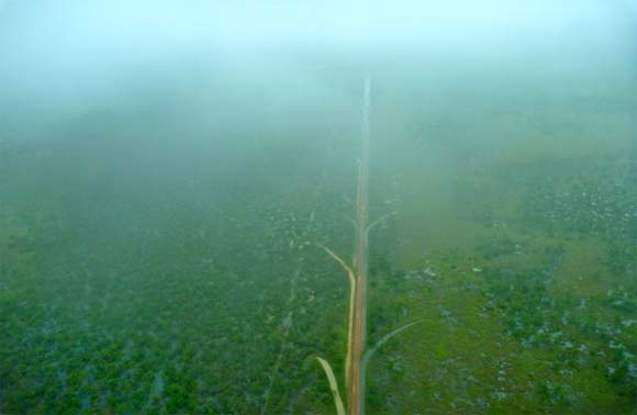 An aerial view of a flooded service road.