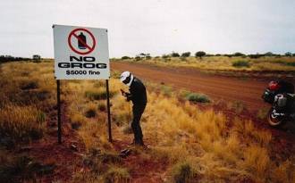 'No grog' sign on a remote outback road.
