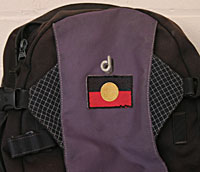 A day pack with an Aboriginal flag stitched onto it.