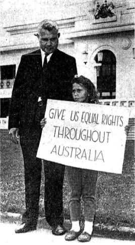 J Hassen and daughter protesting in front of Parliament House. Their sign reads: 'Give us equal rights throughout Australia'.
