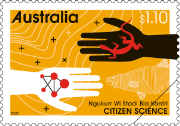 A stamp showing a white hand holding symbolised atoms and a black hand holding the outline of a lizard..
