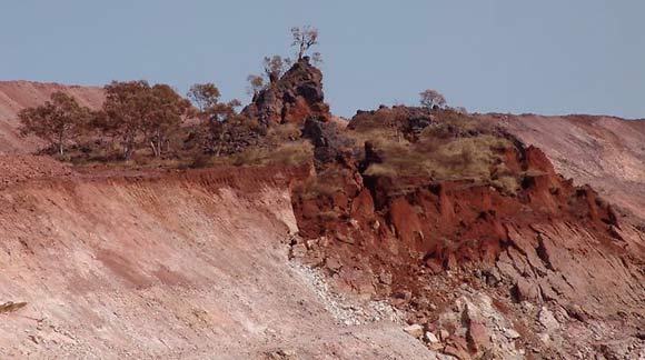 An Aboriginal sacred site surrounded by a mining site where one half has dropped down a few metres.