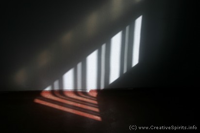 Circle sentencing: The shadow of a barred window slowly crouching along an empty prison cell's floor.