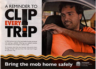 Advertisement reading 'A reminder to clip every trip - Bring the mob home savely', showing an Aboriginal driver reaching for the buckle.