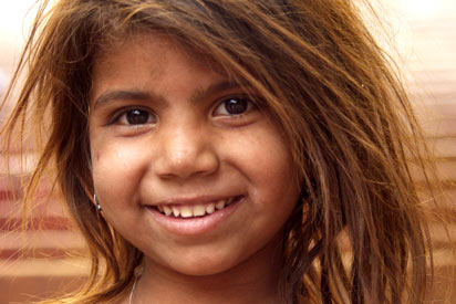 An Indigenous child smiling.