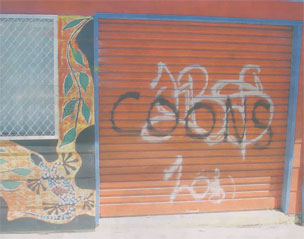 A 'Coon' graffiti has been sprayed on an Aboriginal youth organisation's gate.