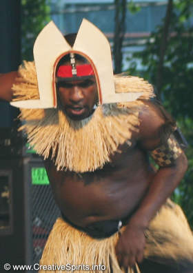 A Torres Strait Islander man dances wearing a dhari.