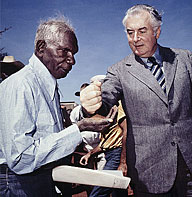 Prime Minister Gough Whitlam pours soil into the hand of Aboriginal elder Vincent Lingiari.