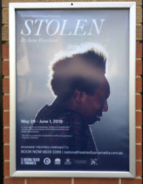 A poster of a Stolen Generations play shows the head of an Aboriginal woman.