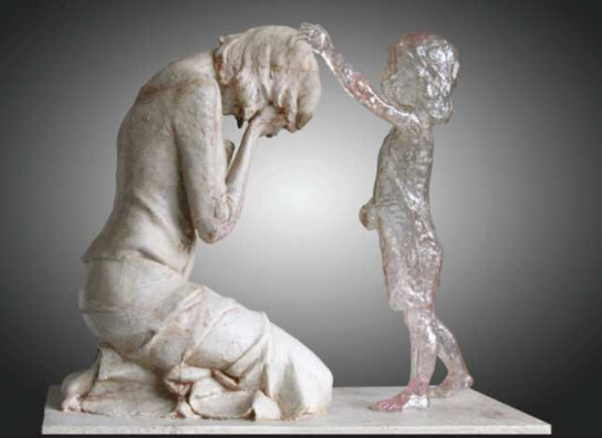 A sculpture shows a woman in great sorrow grieving her abortion, with her unborn represented by a translucent child reaching out to her.