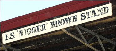 Sign reading 'ES Nigger Brown Stand'.