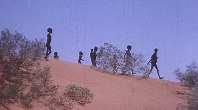Photo: The Martu Aboriginal people walking in the desert.