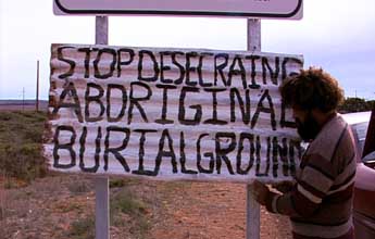 Quenten Agius puts up a protest sign.