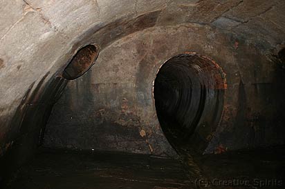 Tank Stream underground. Note the two different sections and a rain water drain top left. Modern drains would meet the stream at ground level to minimise impact on the running water.