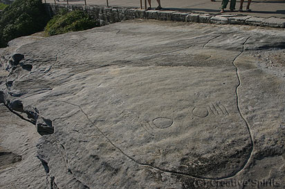 MacKenzies Point. The engraving shows a large whale and a small fish. The walkway is directly to the right of the engraving and seems to cover one fin.